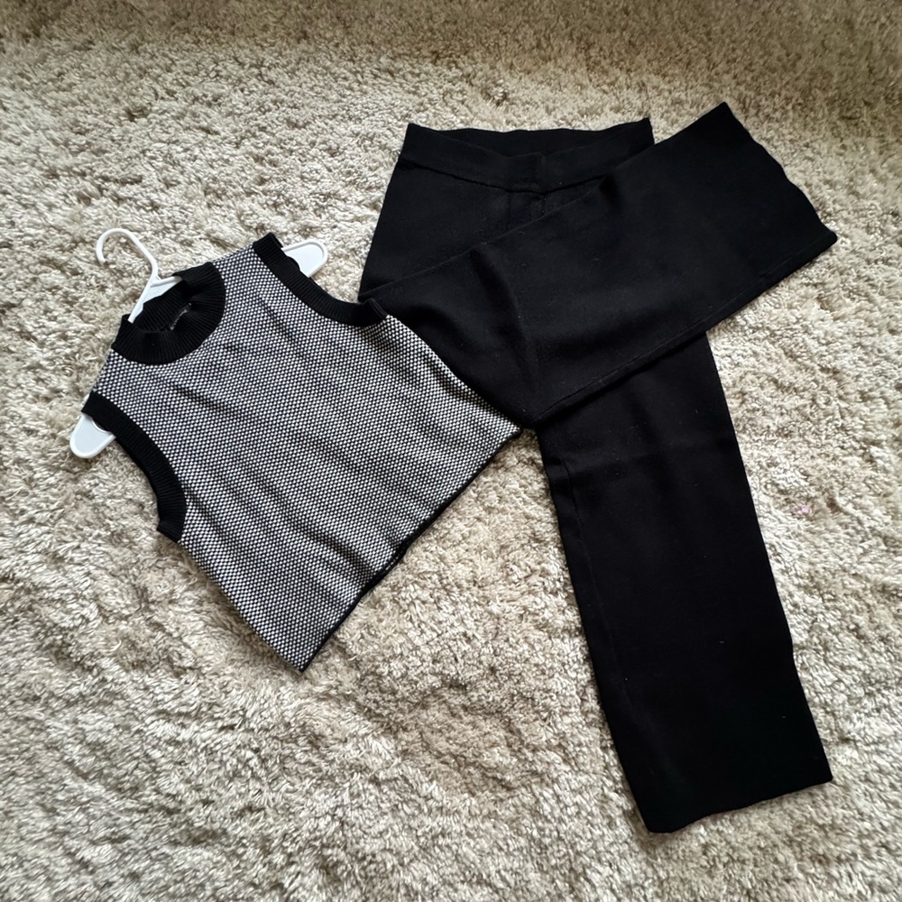 Black and White Sleeveless Top with Black Pants